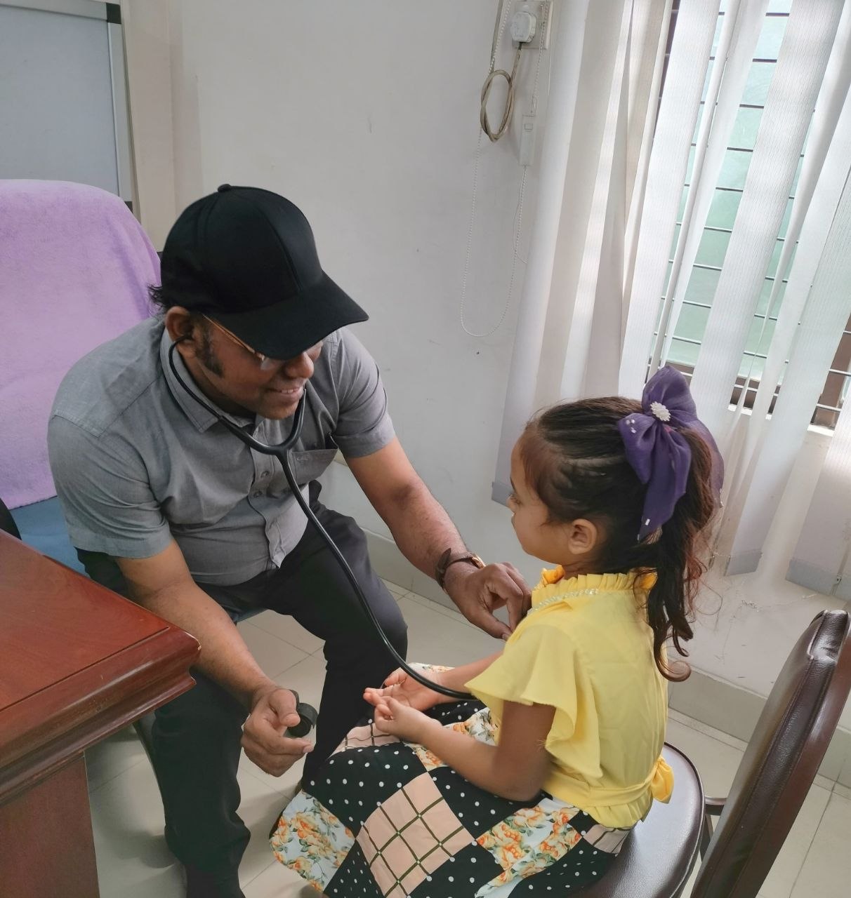 Doctor Monir treating a child in his chamber